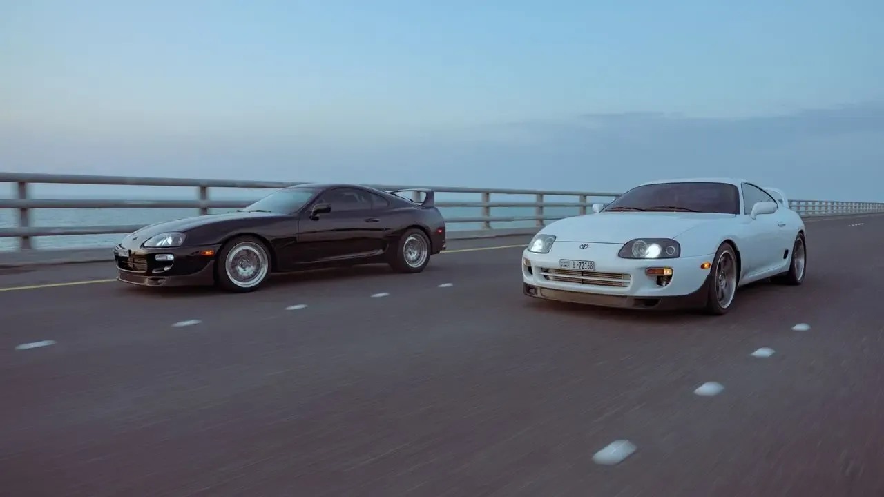 Two Toyota Supra Mk4s on a highway