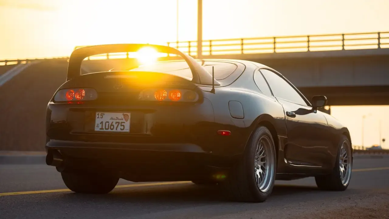 A Toyota Supra Mk4, rear three-quarter in low light