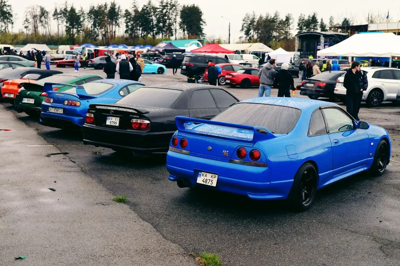 A lineup of JDM cars at a meet