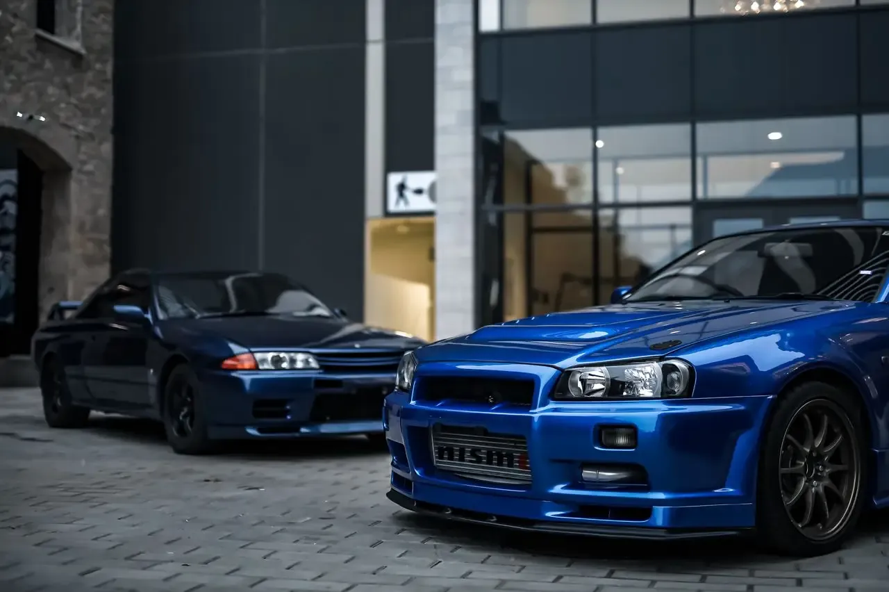 A Nissan Skyline R32 GT-R alongside an R34